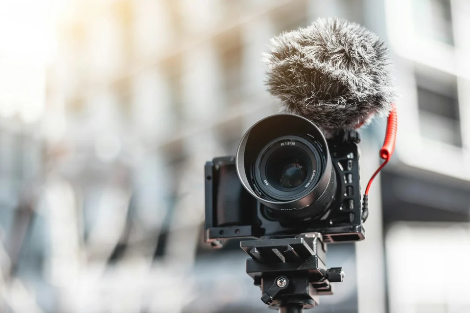 A camera with a microphone mounted above it